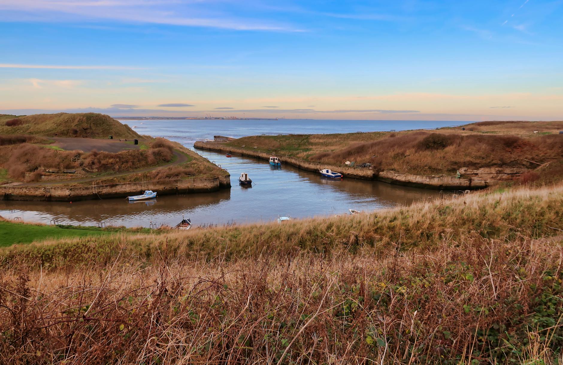 A mouth of a river, with a boat on it.