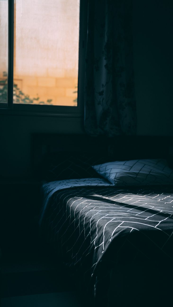 a photo of a dark bedroom